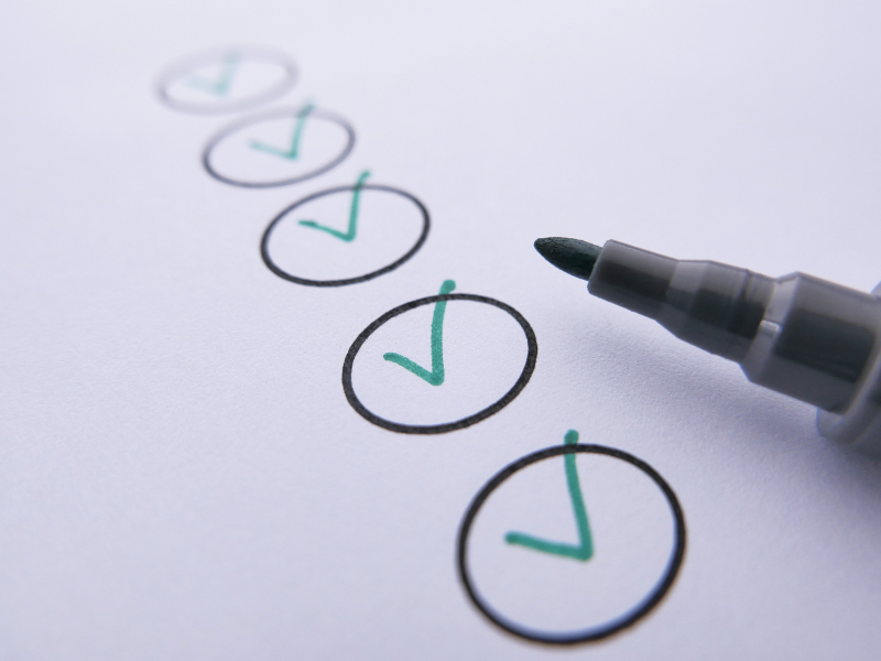 Circles on paper with ticks through the middle showing a checklist with a felt tip pen