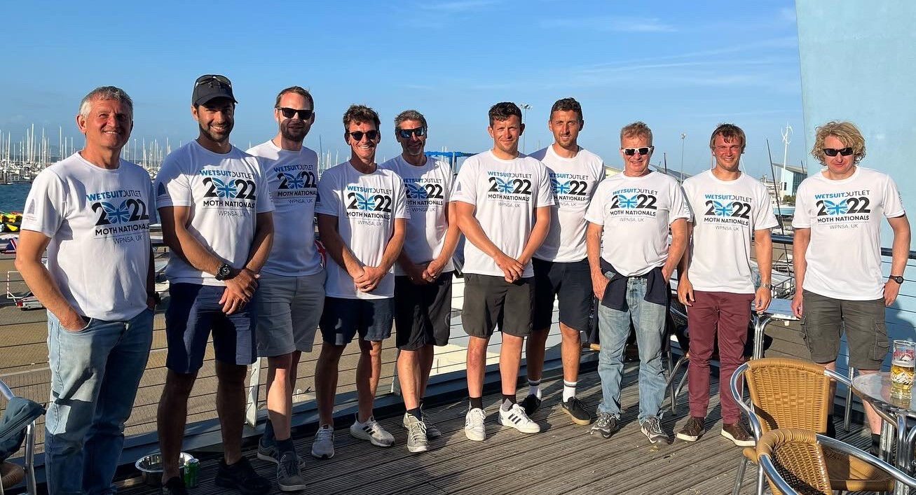 Group of male sailors wearing white printed t-shirts