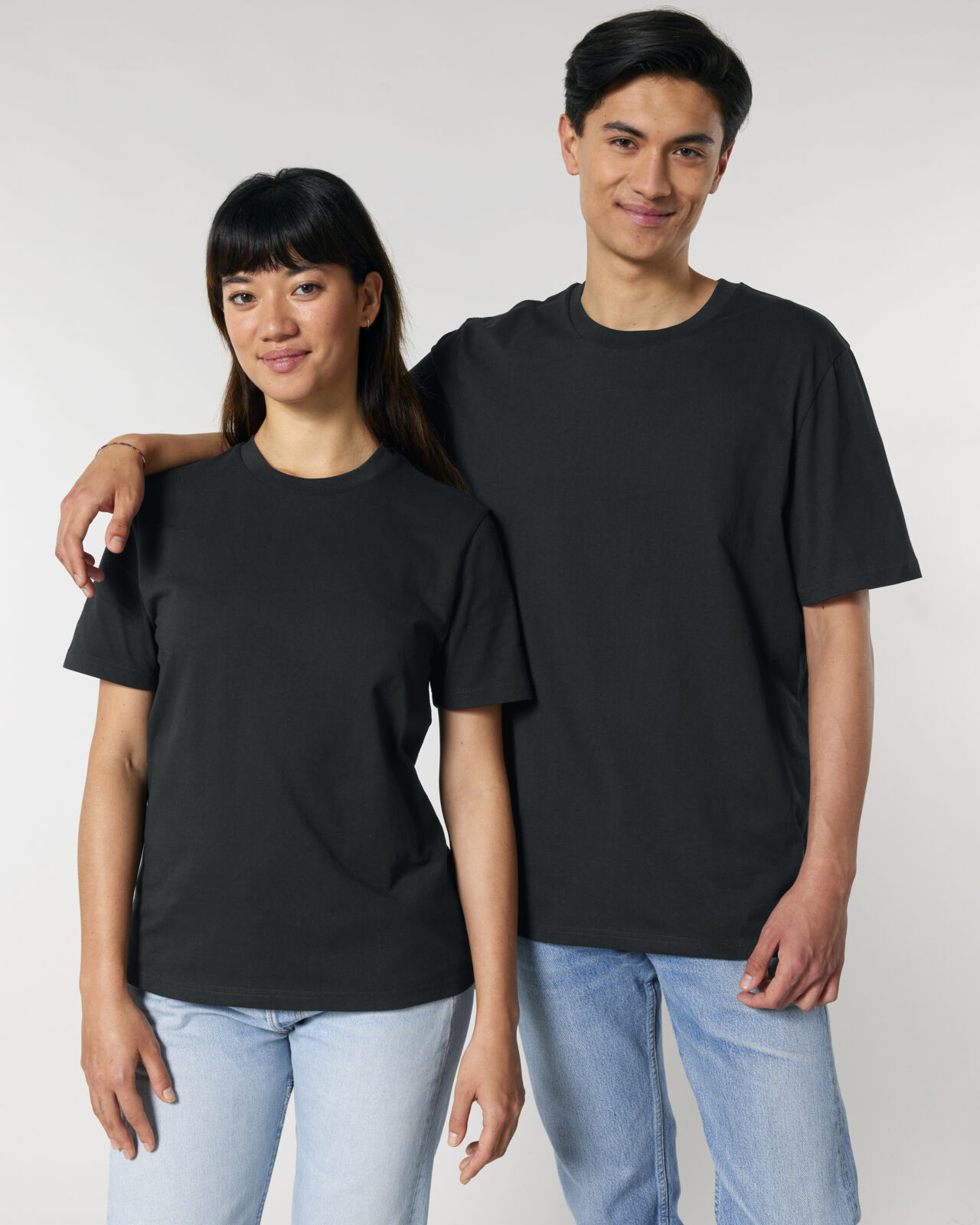 Man and women wearing black sustainable t-shirts