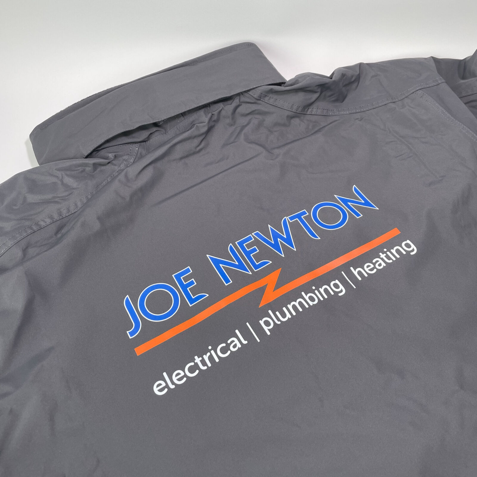 Printed jacket with blue, orange and white logo