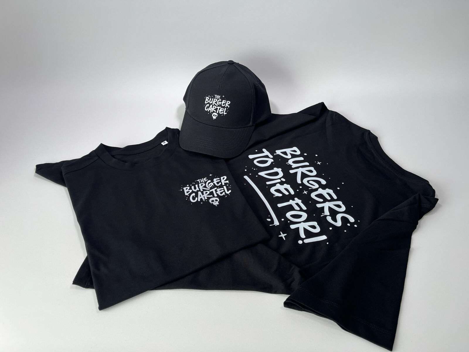 Printed black t-shirt and cap with the burger cartel logos